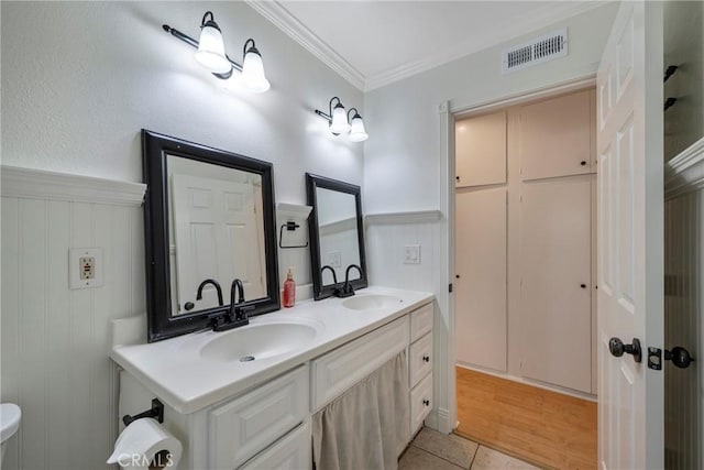 18342 Avolinda Dr, Yorba Linda, CA 92886 - bathroom with double vanity, ornamental molding, a wainscoted wall, and tile patterned floors