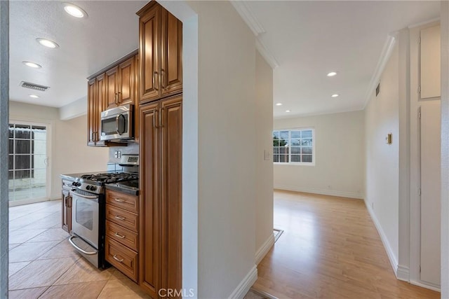 18342 Avolinda Dr, Yorba Linda, CA 92886 - kitchen featuring stainless steel appliances, ornamental molding, brown cabinetry, recessed lighting, and baseboards