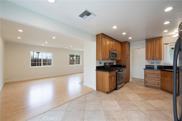 18342 Avolinda Dr, Yorba Linda, CA 92886 - kitchen featuring appliances with stainless steel finishes, dark countertops, recessed lighting, brown cabinetry, and open floor plan