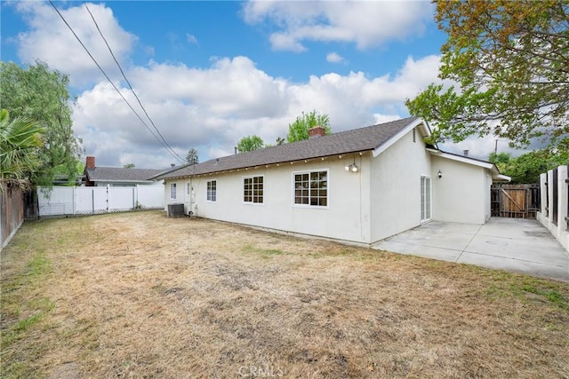 18342 Avolinda Dr, Yorba Linda, CA 92886 - back of property with a patio area, stucco siding, a chimney, central AC, and a shingled roof