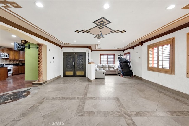 interior space with recessed lighting, baseboards, ornamental molding, and french doors