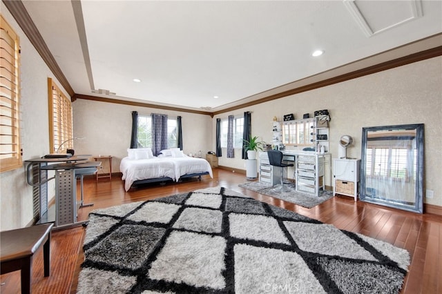 bedroom featuring baseboards, wood finished floors, recessed lighting, and crown molding
