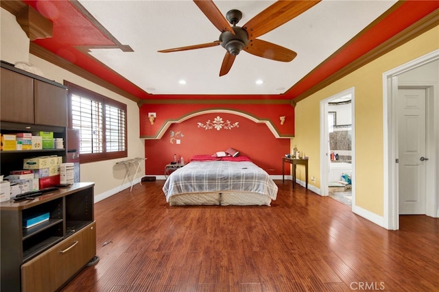 bedroom with recessed lighting, wood finished floors, crown molding, and baseboards