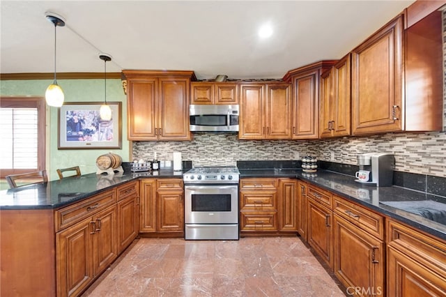 kitchen with brown cabinets, a peninsula, and appliances with stainless steel finishes