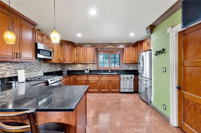 kitchen with tasteful backsplash, brown cabinetry, decorative light fixtures, a peninsula, and appliances with stainless steel finishes