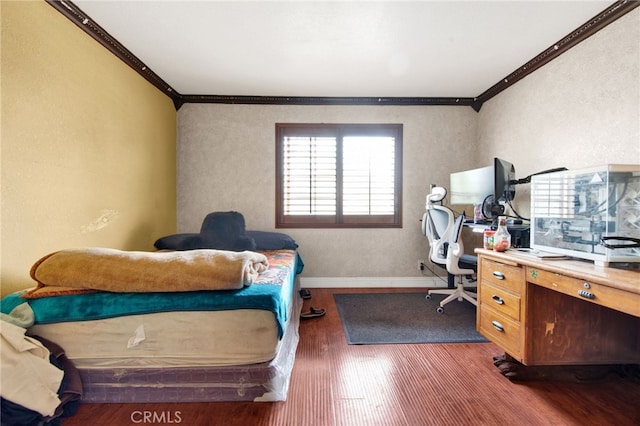 office area with baseboards, ornamental molding, wood finished floors, and a textured wall