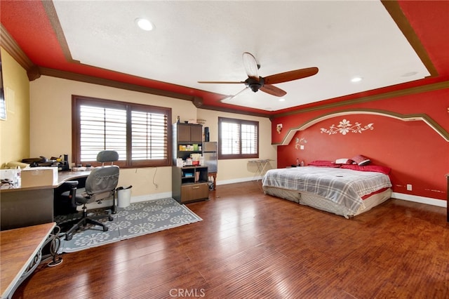 bedroom featuring a ceiling fan, wood finished floors, baseboards, ornamental molding, and recessed lighting