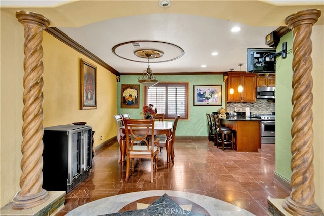 dining area featuring recessed lighting, baseboards, crown molding, and decorative columns