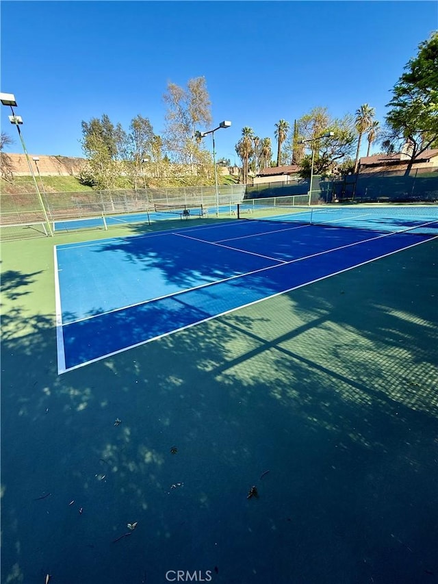 view of sport court featuring fence