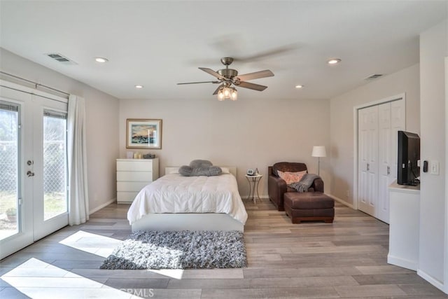bedroom featuring access to outside, french doors, light wood finished floors, and visible vents