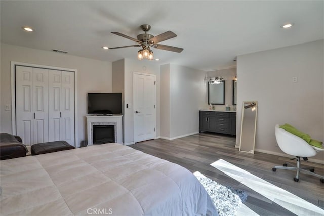 bedroom with baseboards, recessed lighting, and wood finished floors