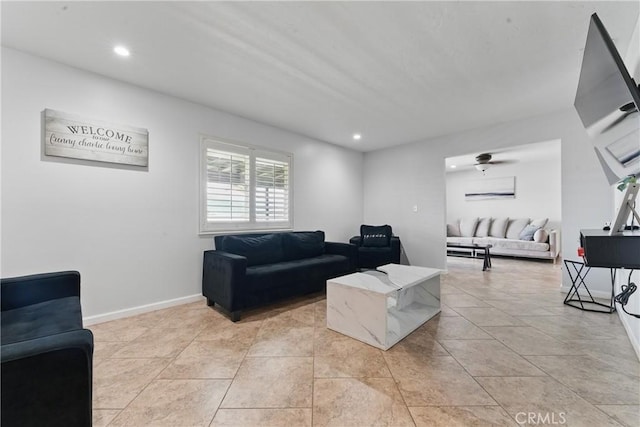 living area featuring light tile patterned floors, baseboards, and recessed lighting