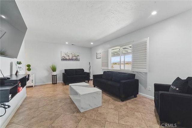 living room featuring baseboards, a textured ceiling, recessed lighting, and light tile patterned flooring