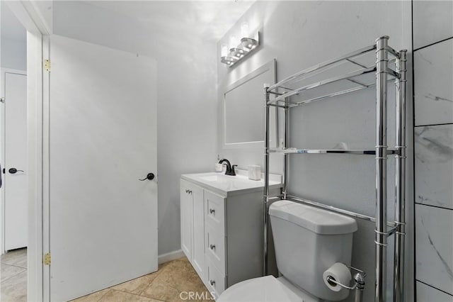 bathroom featuring toilet, tile patterned flooring, and vanity