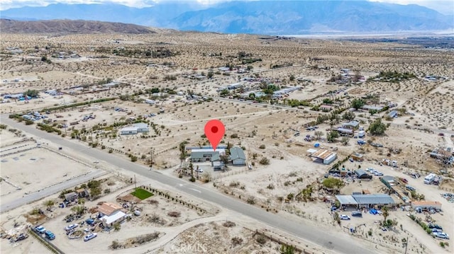 drone / aerial view featuring a mountain view, a rural view, and view of desert