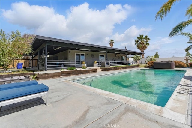 view of swimming pool featuring a patio, a jacuzzi, and a fenced in pool
