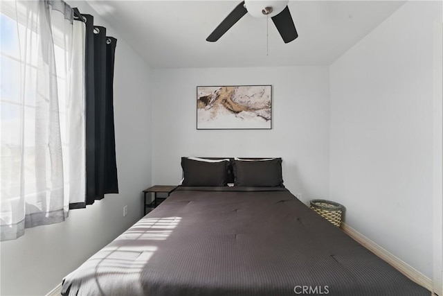 bedroom featuring baseboards and a ceiling fan