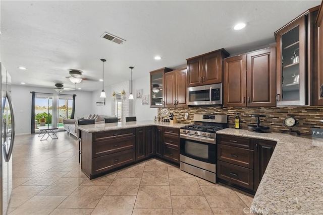 kitchen featuring visible vents, a peninsula, tasteful backsplash, appliances with stainless steel finishes, and open floor plan