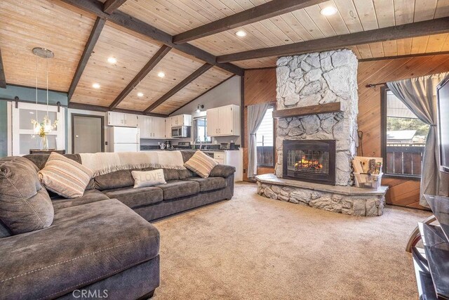 1066 Paradise Way, Big Bear City, CA 92314 - living room featuring wood ceiling, vaulted ceiling with beams, wooden walls, and light colored carpet
