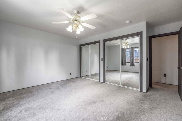 1066 Paradise Way, Big Bear City, CA 92314 - unfurnished bedroom featuring two closets, carpet flooring, and ceiling fan