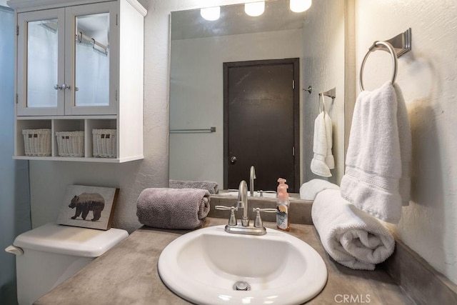 1066 Paradise Way, Big Bear City, CA 92314 - bathroom with a textured wall, toilet, and a sink