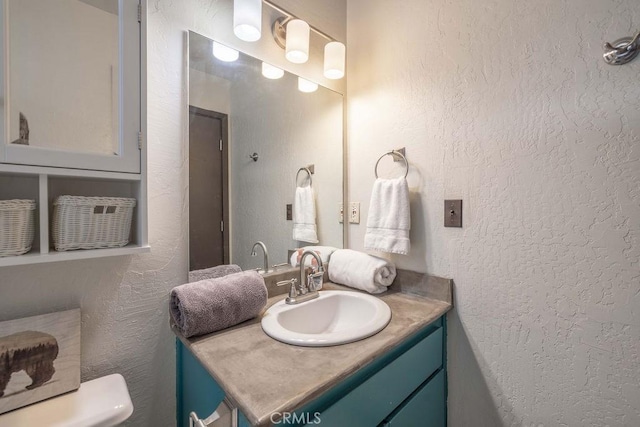 1066 Paradise Way, Big Bear City, CA 92314 - bathroom featuring toilet, vanity, and a textured wall