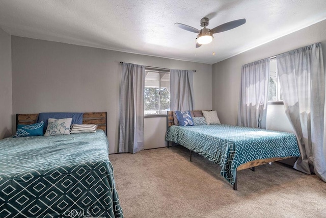 1066 Paradise Way, Big Bear City, CA 92314 - bedroom featuring a textured ceiling, carpet, and a ceiling fan