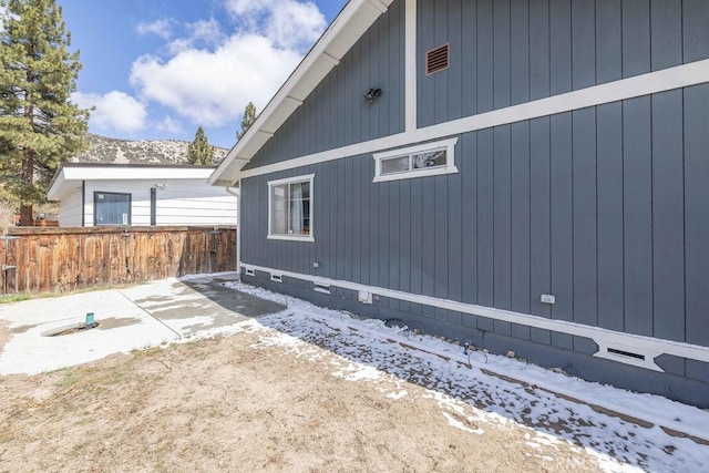 1066 Paradise Way, Big Bear City, CA 92314 - view of snow covered exterior with crawl space, fence, and a patio