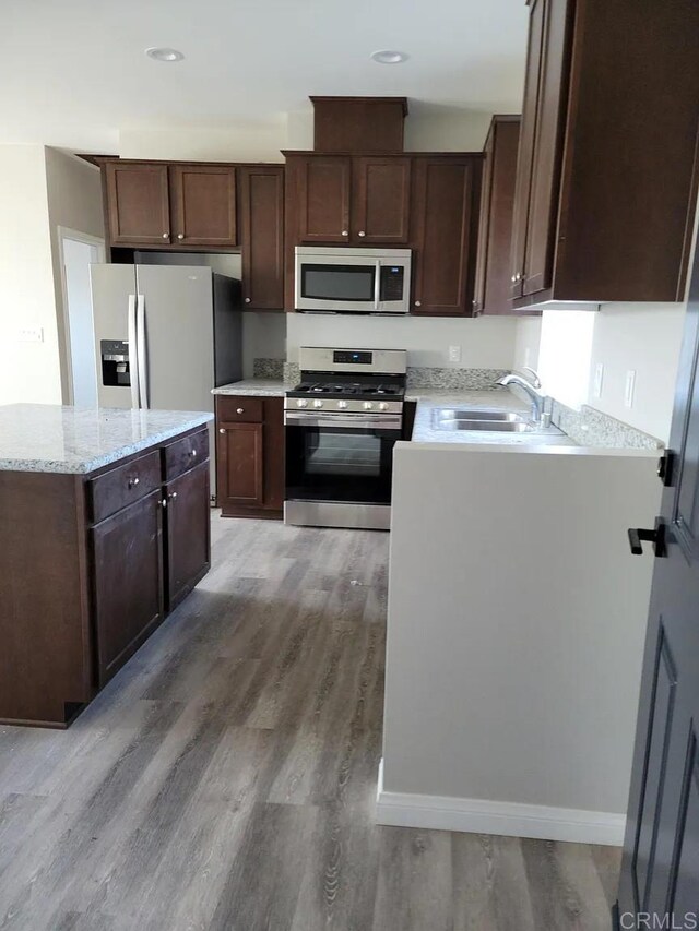 11311135 Emory St, Imperial Beach, CA 91932 - kitchen featuring appliances with stainless steel finishes, a sink, light wood-style floors, dark brown cabinets, and recessed lighting