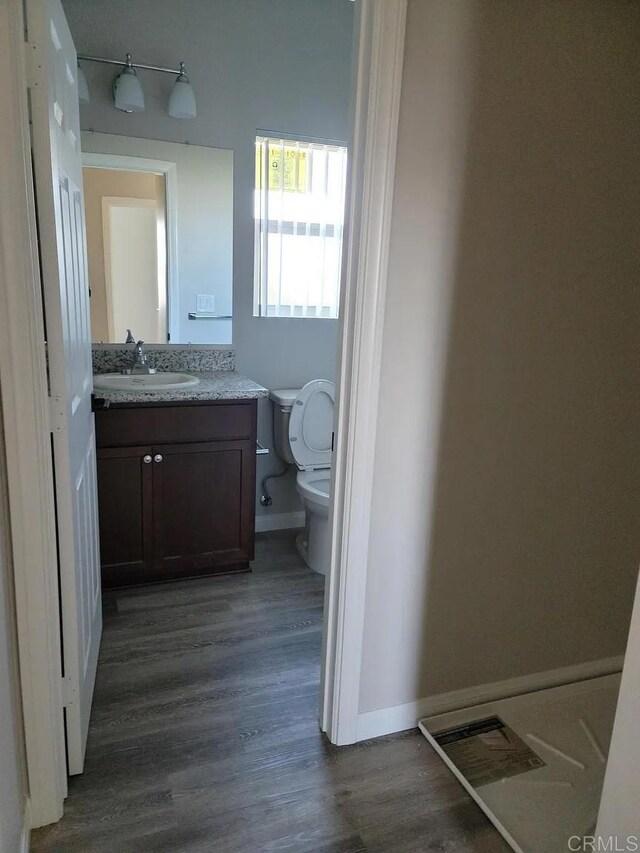 11311135 Emory St, Imperial Beach, CA 91932 - bathroom featuring wood finished floors, toilet, vanity, and baseboards