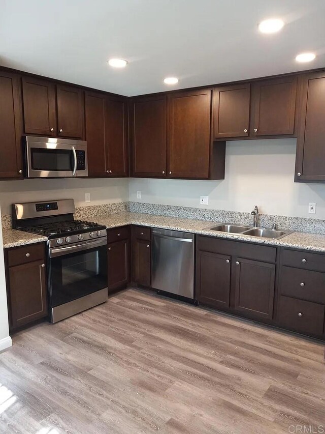 11311135 Emory St, Imperial Beach, CA 91932 - kitchen with appliances with stainless steel finishes, a sink, dark brown cabinetry, recessed lighting, and light wood-type flooring