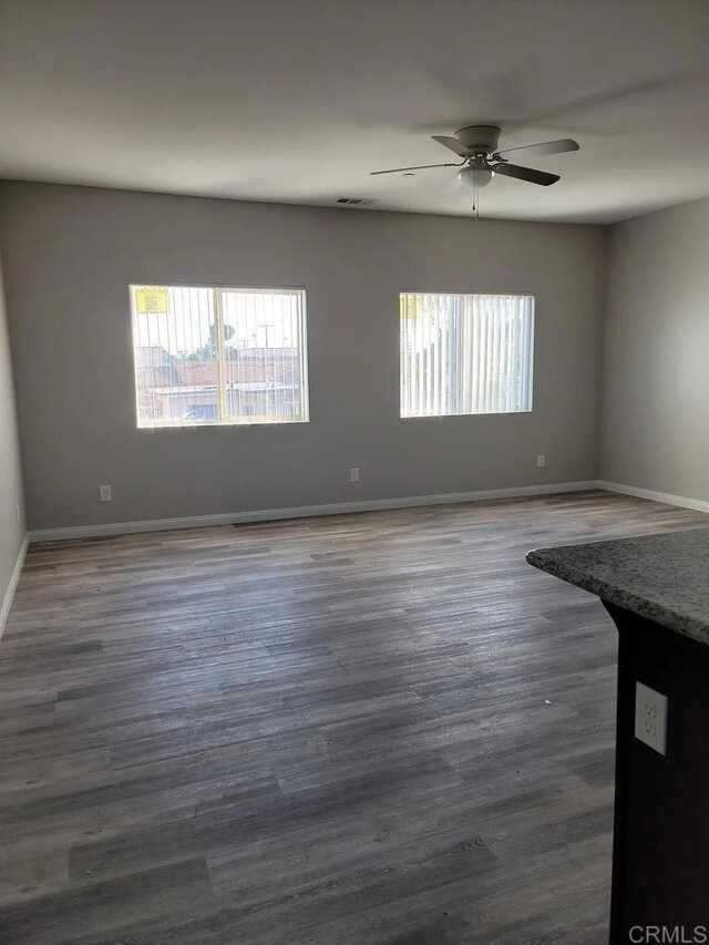 11311135 Emory St, Imperial Beach, CA 91932 - empty room featuring plenty of natural light, a ceiling fan, baseboards, and dark wood finished floors