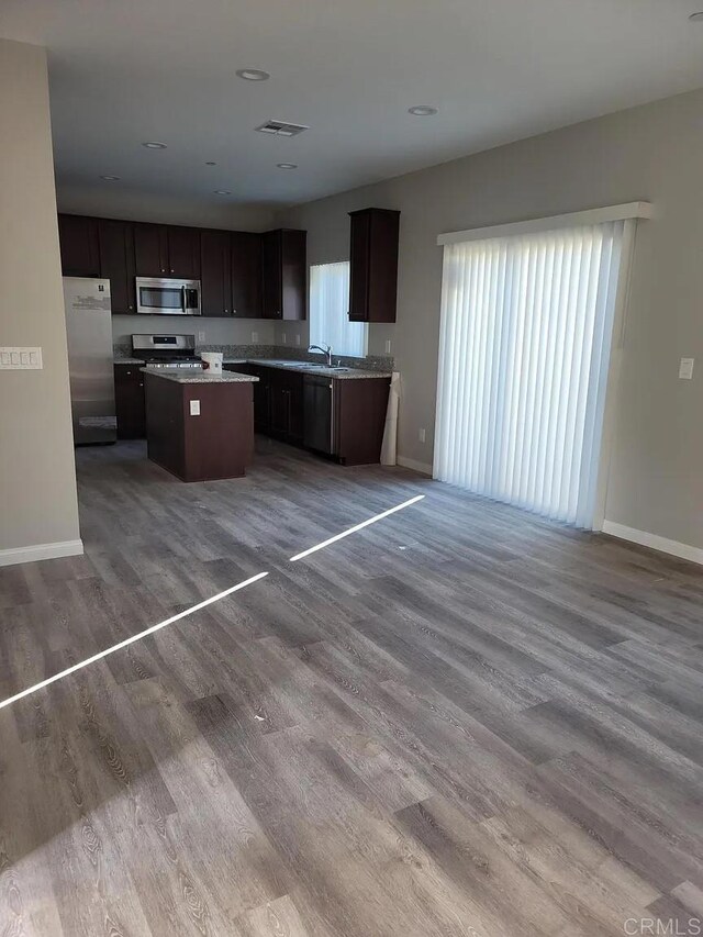 11311135 Emory St, Imperial Beach, CA 91932 - kitchen with appliances with stainless steel finishes, a sink, a kitchen island, baseboards, and open floor plan