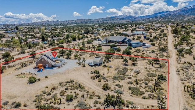 aerial view featuring a mountain view and a desert view