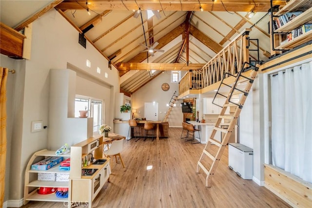 entryway featuring high vaulted ceiling, stairs, beam ceiling, and wood finished floors