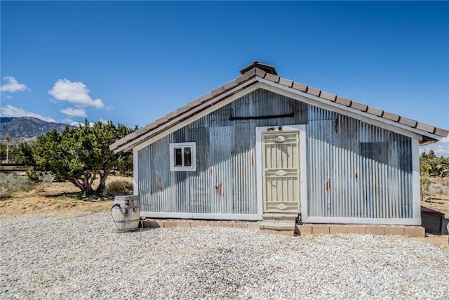 view of outbuilding featuring a mountain view and an outdoor structure