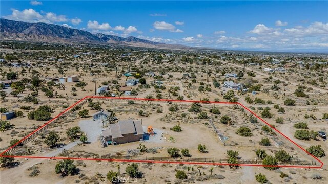birds eye view of property with a rural view, a mountain view, and a desert view