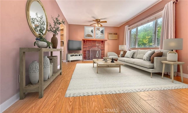 3611 4th Ave, La Crescenta, CA 91214 - living area featuring ceiling fan, a fireplace, light wood-style flooring, baseboards, and an AC wall unit