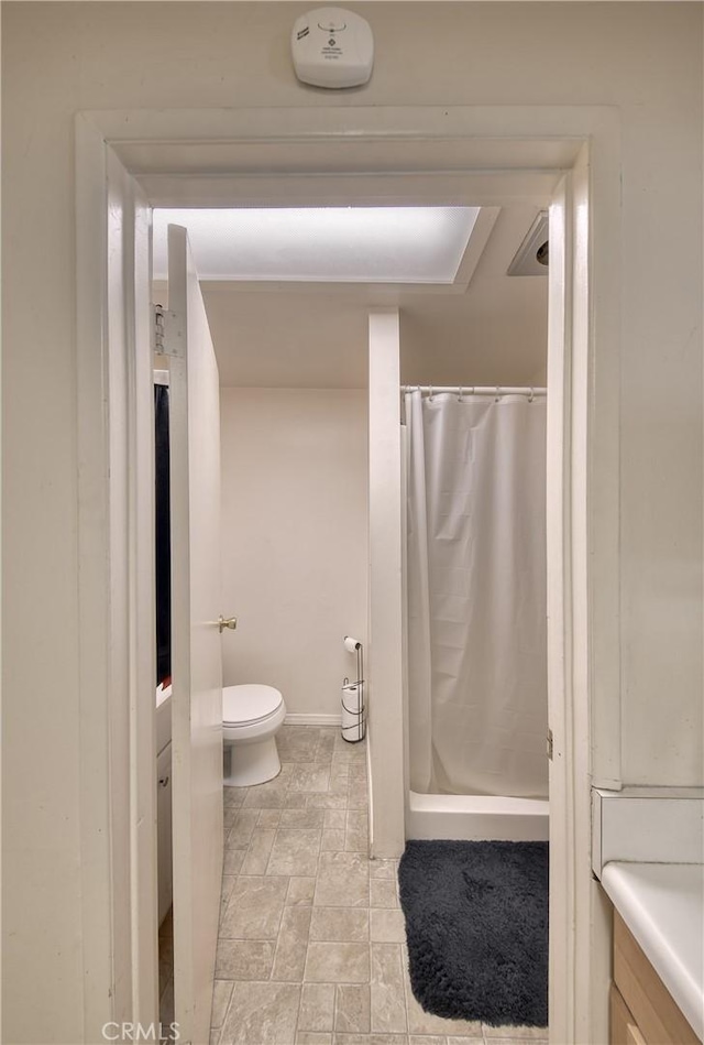 3611 4th Ave, La Crescenta, CA 91214 - full bath with vanity, toilet, curtained shower, and stone finish floors