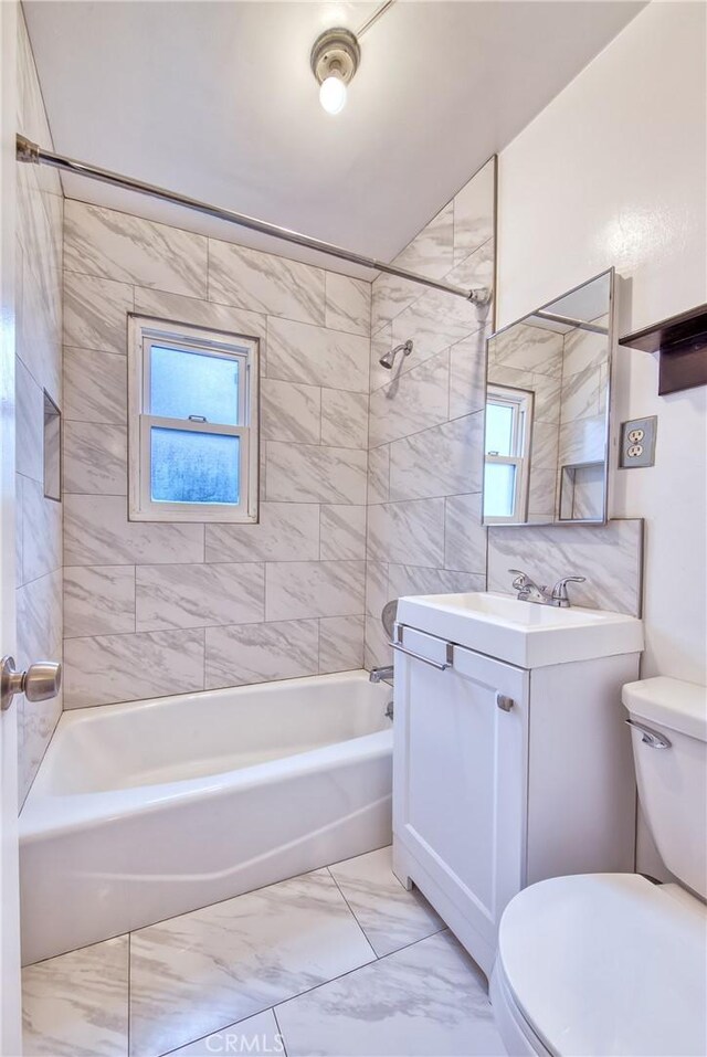 3611 4th Ave, La Crescenta, CA 91214 - bathroom featuring toilet, vanity,  shower combination, and marble finish flooring