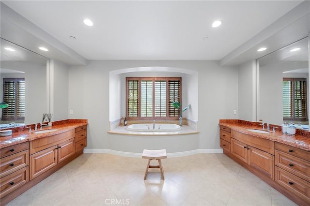 full bathroom with recessed lighting, two vanities, and a sink
