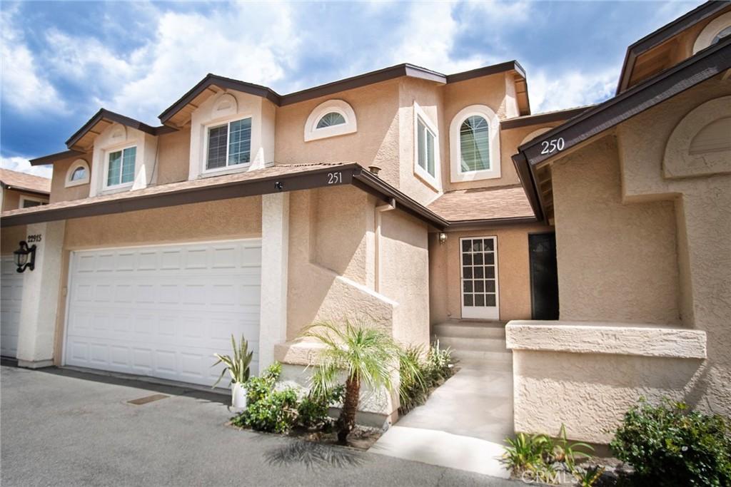 22915 Banyan Pl Unit 251, Saugus, CA 91390 - view of front of house with stucco siding and an attached garage