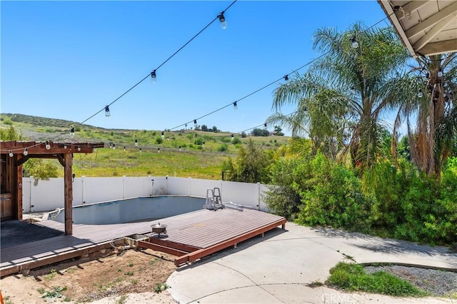 view of patio with fence and a deck