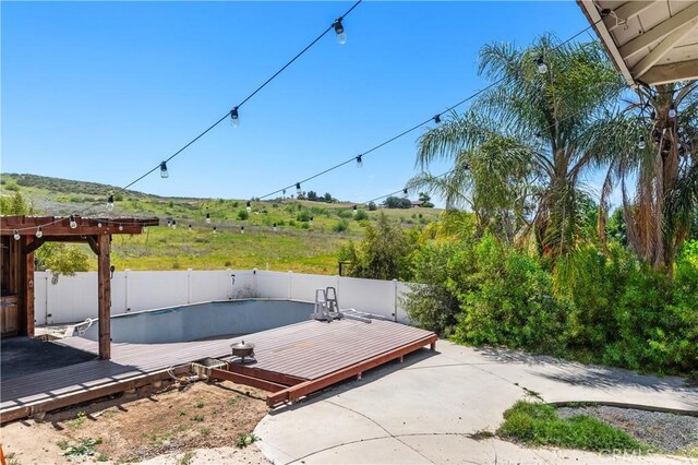 14445 Dove Canyon Dr, Riverside, CA 92503 - view of patio featuring a wooden deck and a fenced backyard