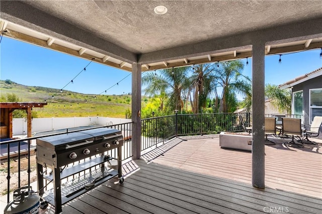 deck with outdoor dining space and fence
