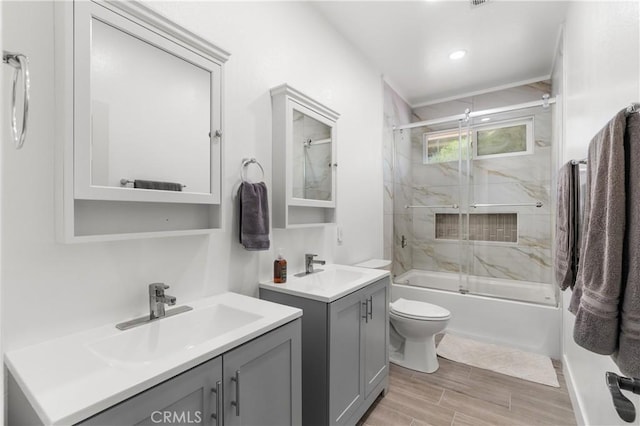 14445 Dove Canyon Dr, Riverside, CA 92503 - bathroom featuring combined bath / shower with glass door, wood finished floors, two vanities, toilet, and recessed lighting