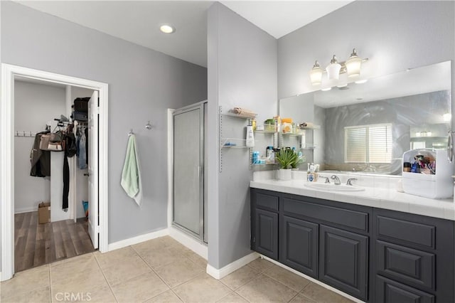 14445 Dove Canyon Dr, Riverside, CA 92503 - full bath with a shower stall, a spacious closet, vanity, tile patterned flooring, and baseboards