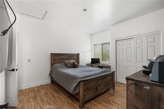 14445 Dove Canyon Dr, Riverside, CA 92503 - bedroom with attic access, light wood-style floors, a closet, and baseboards