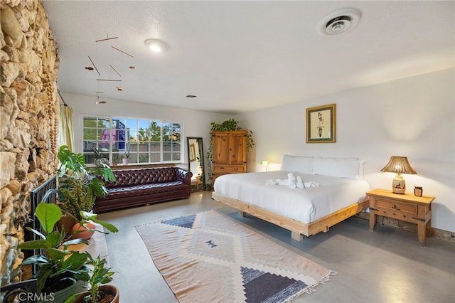 bedroom featuring visible vents and finished concrete floors