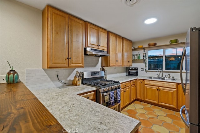 kitchen with open shelves, stainless steel appliances, under cabinet range hood, backsplash, and a sink